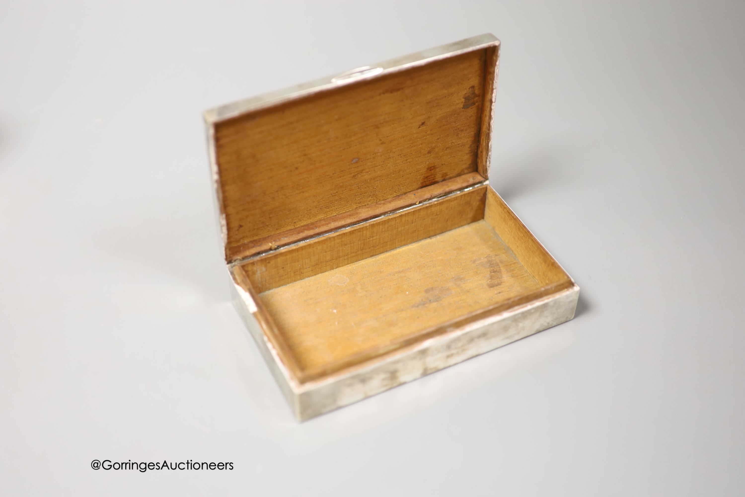 Three 20th century silver mounted cigarette boxes, two with engraved signatures, largest 16.2cm.